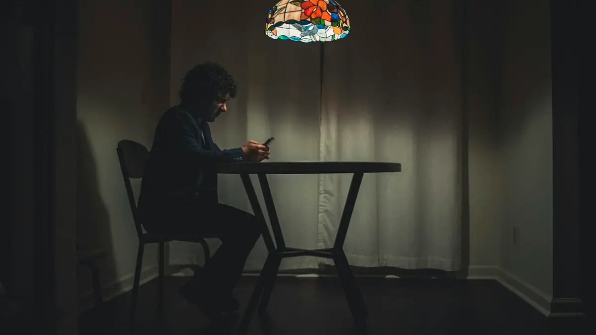 man in black shirt sitting on chair