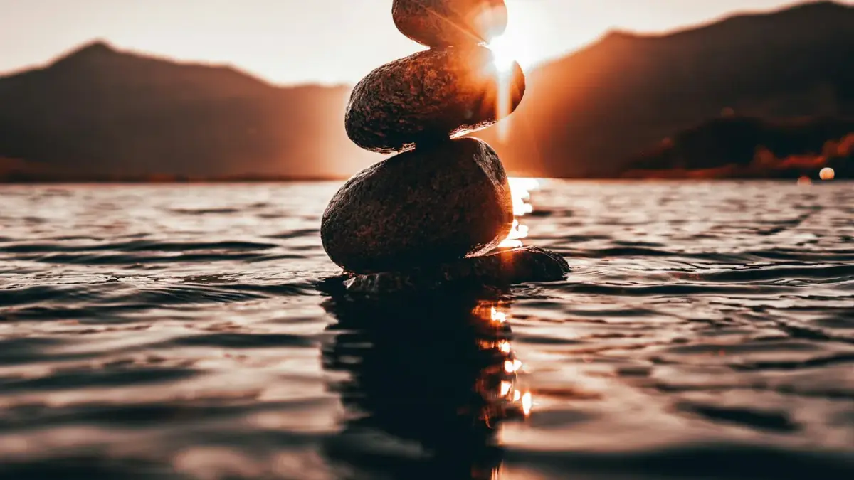 a stack of rocks sitting on top of a body of water