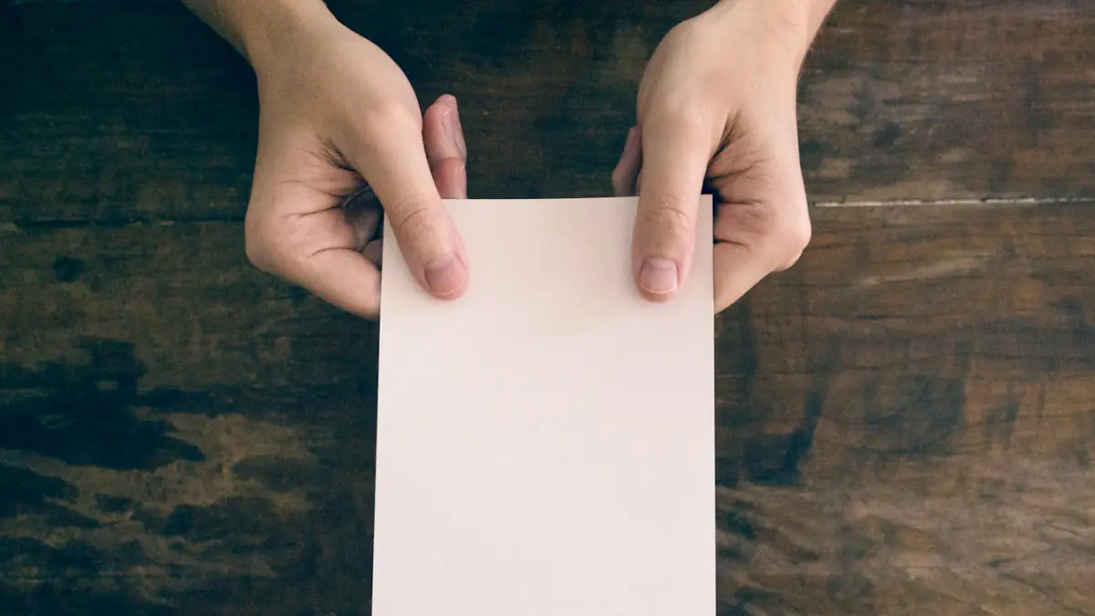 person holding white printer paper