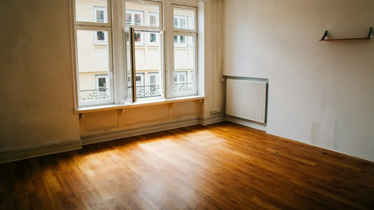 Empty room with wooden floor and large window
