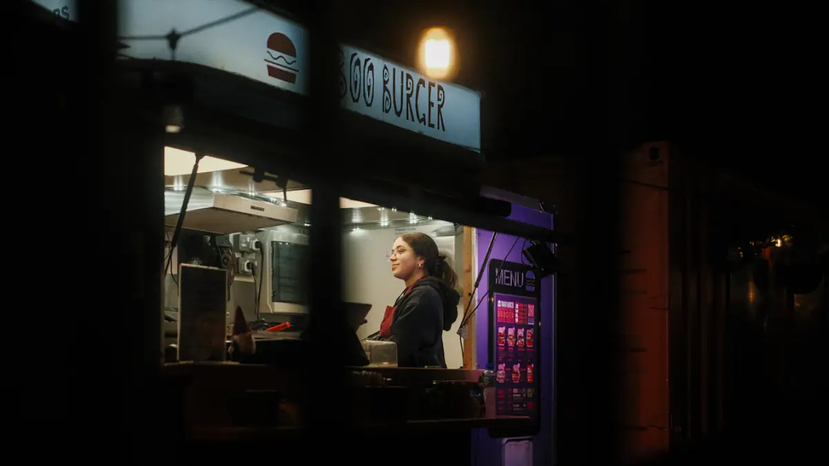 Woman working at a food truck at night